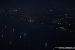 a city at night with lights on the water