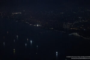 a city at night with lights on the water