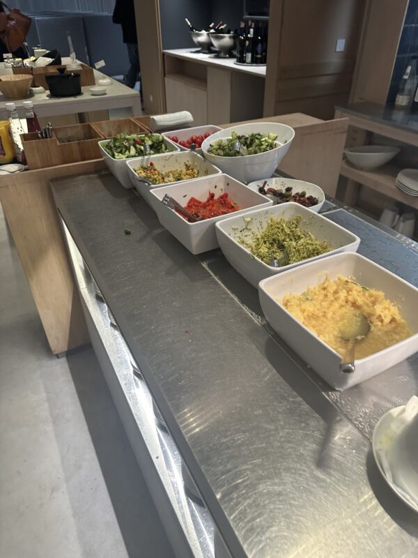 a row of bowls of food on a table