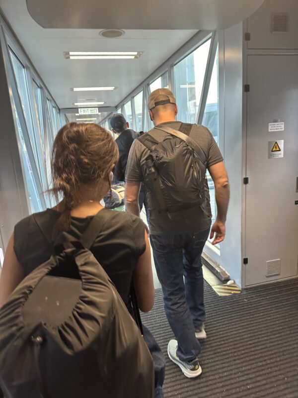 a man and woman walking down a hallway