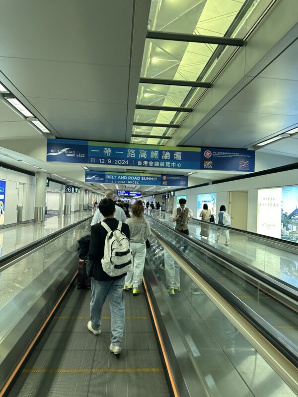 people walking on a moving walkway