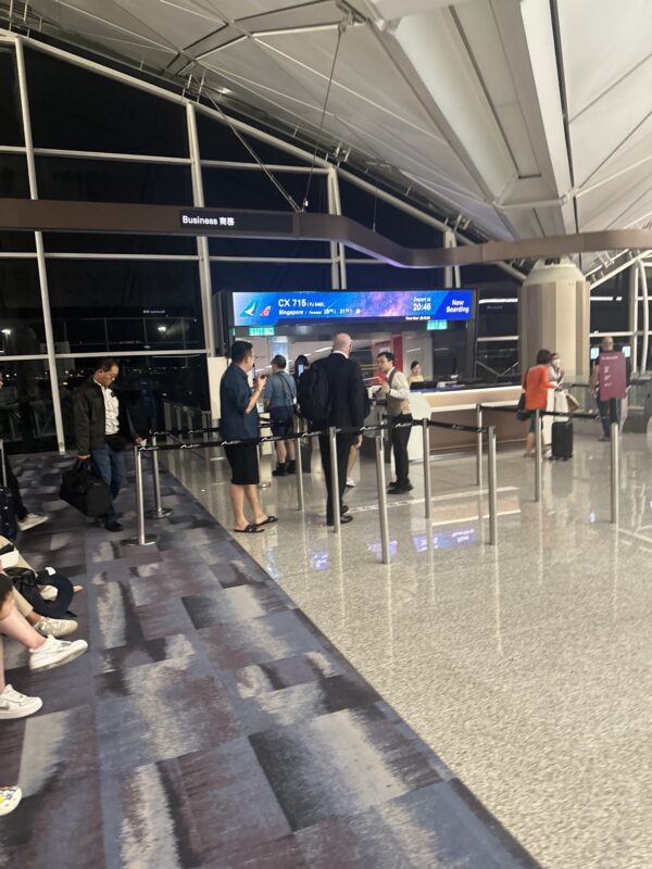 people standing in a line at an airport