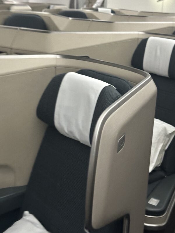 a seat with a white pillow on it