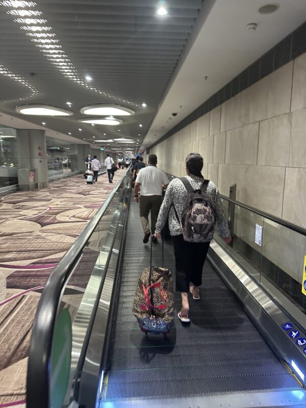 people walking on an escalator