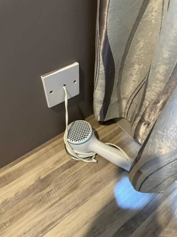 a hair dryer plugged into a wall