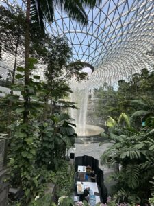 a large indoor waterfall in a glass dome