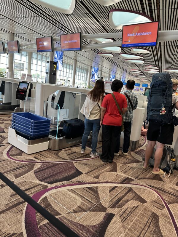 people standing in a line at an airport