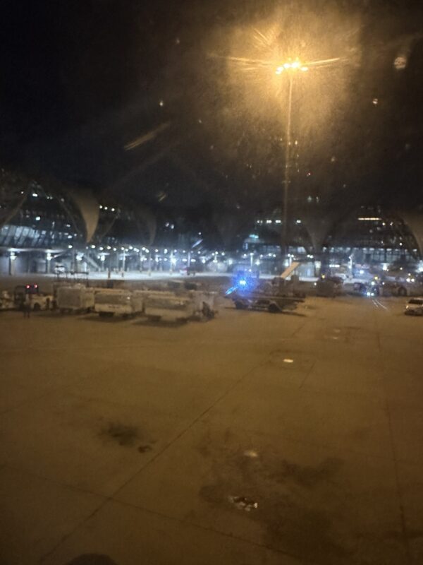 a airport at night with lights and cars