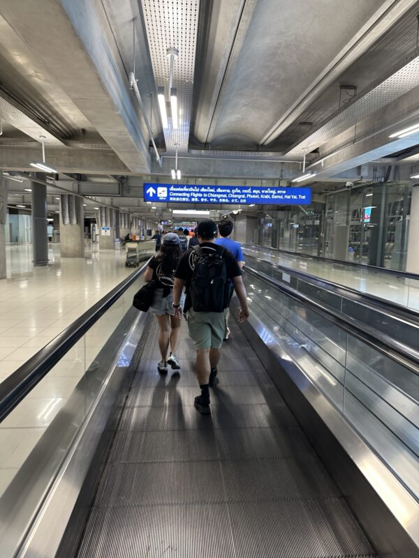 people walking on a moving walkway