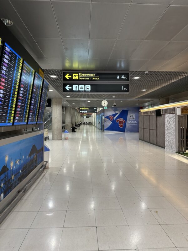 a large airport terminal with signs and information boards