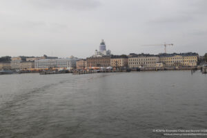 a body of water with buildings and cranes