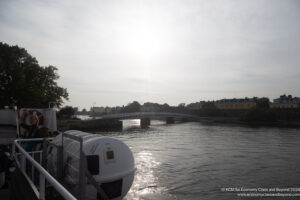 a bridge over a body of water with a boat and a bridge