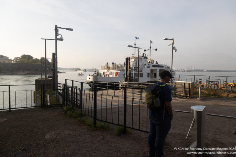 a man standing next to a boat