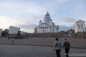 people walking in front of a large building