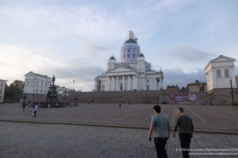 people walking in front of a large building