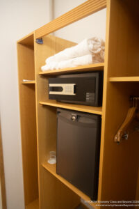 a small black safe on a shelf with a black refrigerator and a black dishwasher