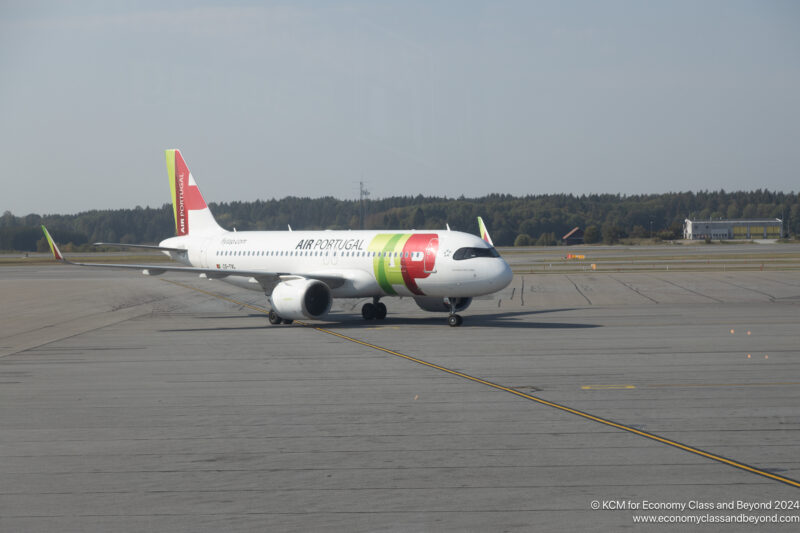 a white airplane on a runway