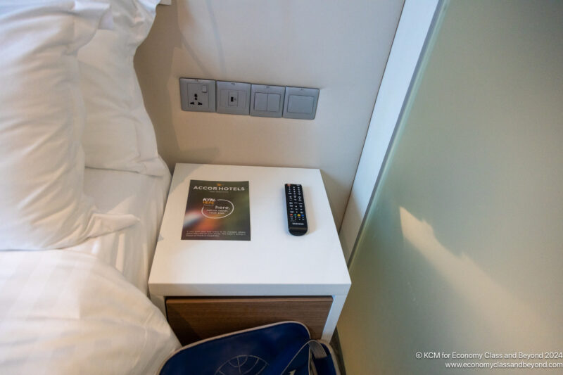 a remote control on a nightstand