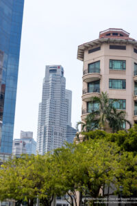 a group of buildings with trees in front of them
