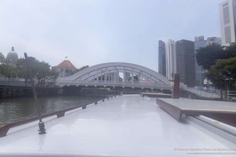 a bridge over water with buildings in the background