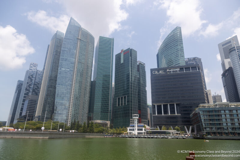 a group of tall buildings next to a body of water