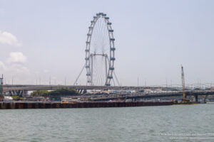 a ferris wheel next to a body of water