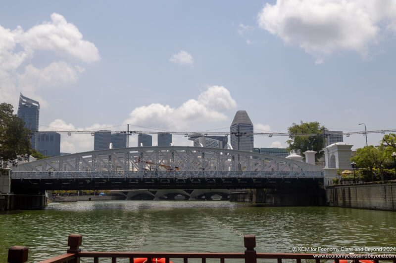 a bridge over water with buildings in the background