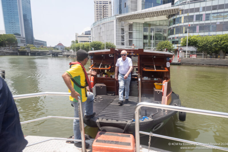 two men standing on a boat