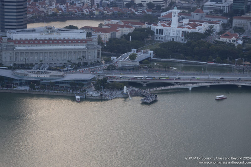 a bridge over water with a bridge and a city