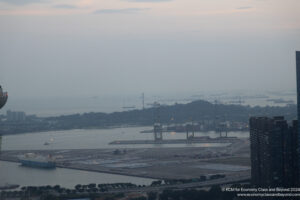 a large port with many cars and a body of water