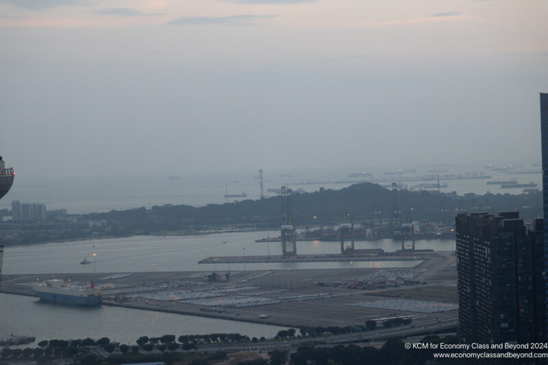 a large port with many cars and a body of water