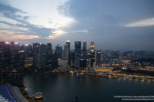 a city skyline with lights and a body of water