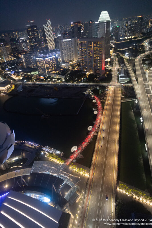 a city at night with a river and buildings