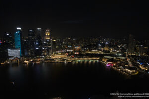 a city at night with lights and a body of water