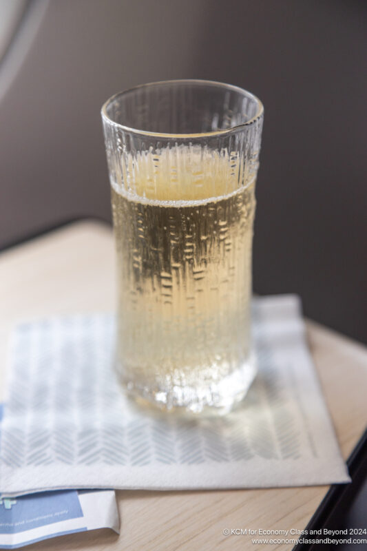 a glass of liquid on a napkin