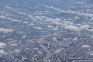 aerial view of a city with a river and clouds