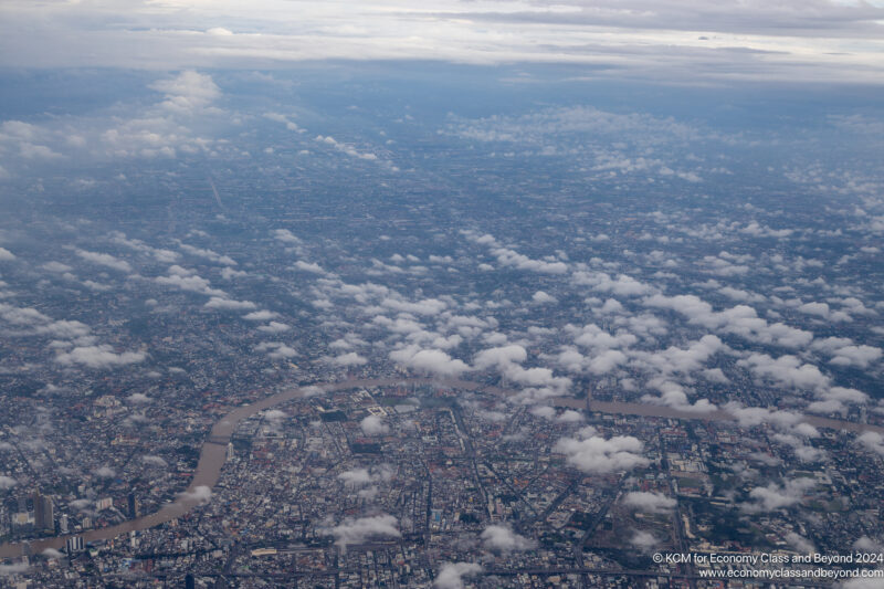 aerial view of a city with a river and clouds