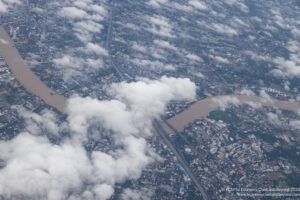 aerial view of a city with clouds and a river