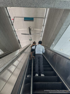 a man and woman on an escalator