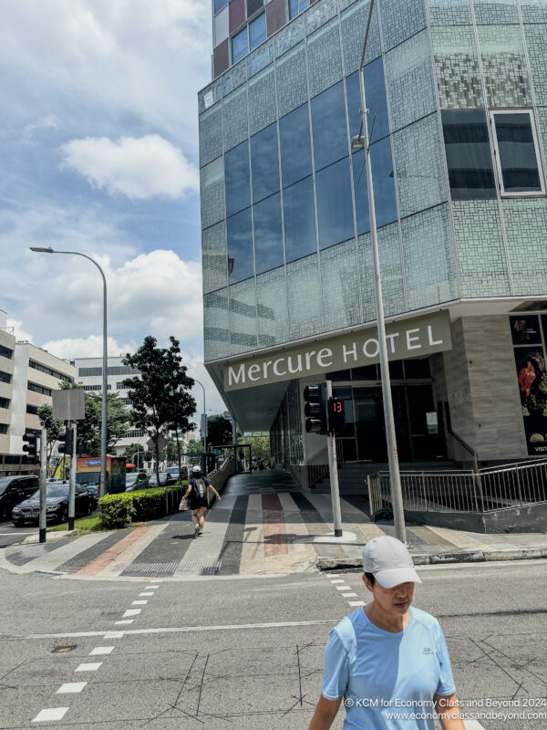 a man in a hat on a street corner