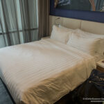 a bed with a white sheet and pillows