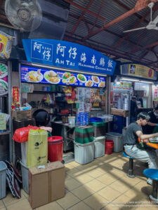 people sitting at a table in a food court