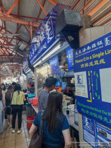 people in a market with signs