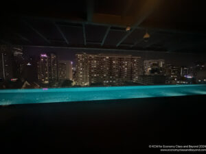 a pool with a city skyline in the background