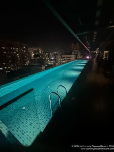 a pool with lights on the side of it