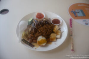 a plate of food with sauces and a spoon