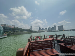 a dock on a body of water with buildings in the background