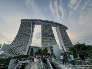 a group of people walking on escalator and a tall building with Museo Soumaya in the background