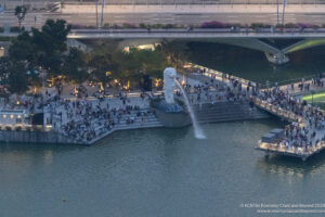a crowd of people around a statue