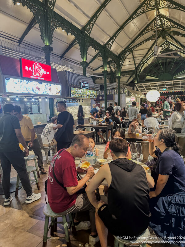 a group of people sitting at tables in a restaurant